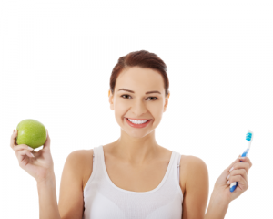 woman smiling holding apple and toothbrush